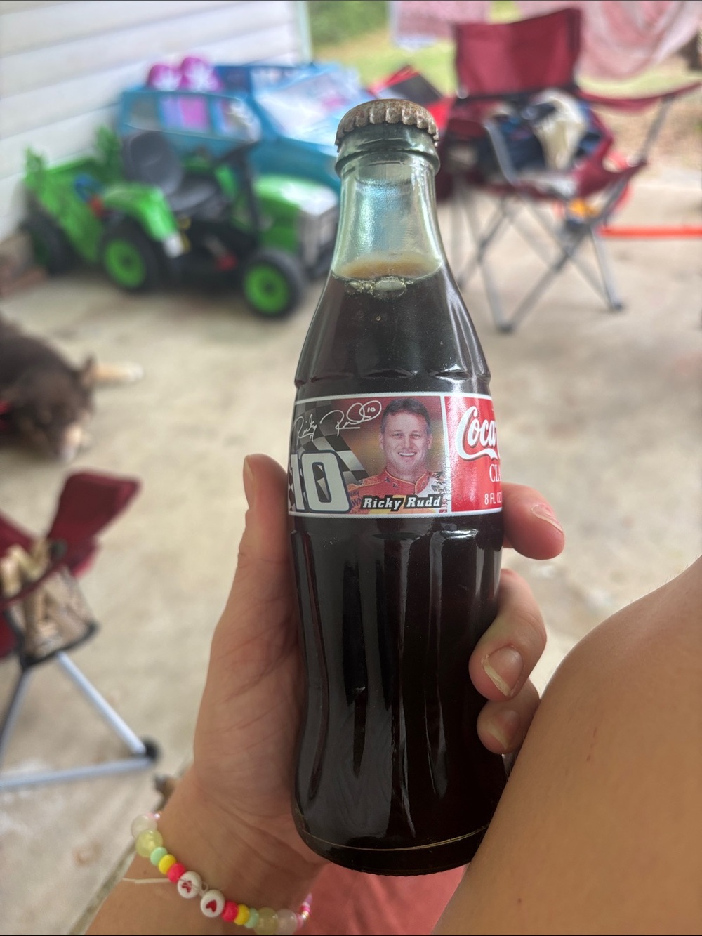 Coca Cola Glass Bottle with Red Label and Dark Beverage